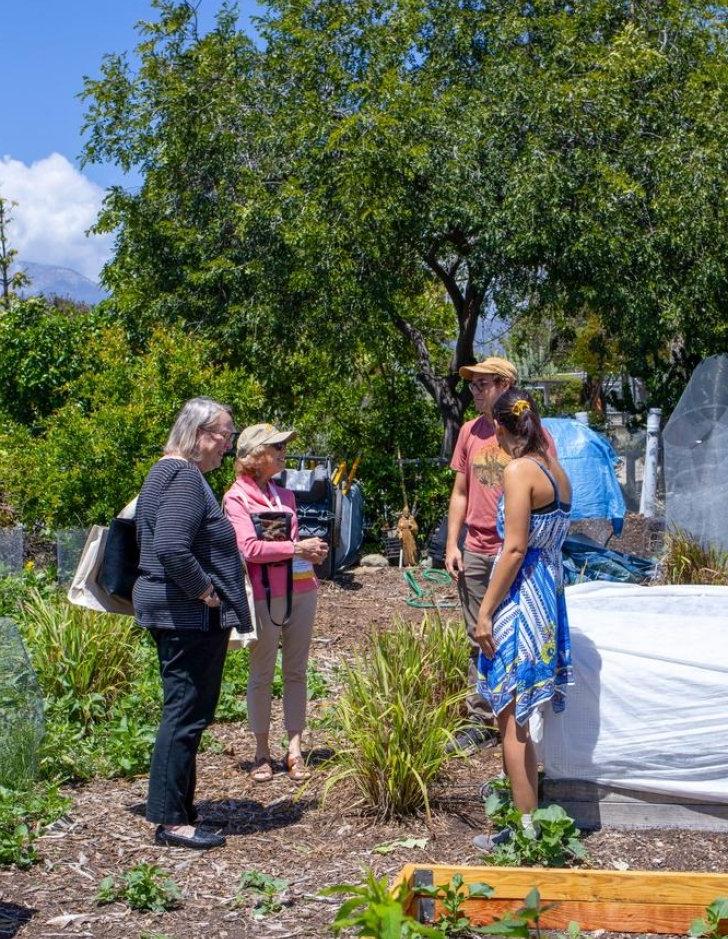 Pitzer alumni tour the student garden during Alumni Weekend